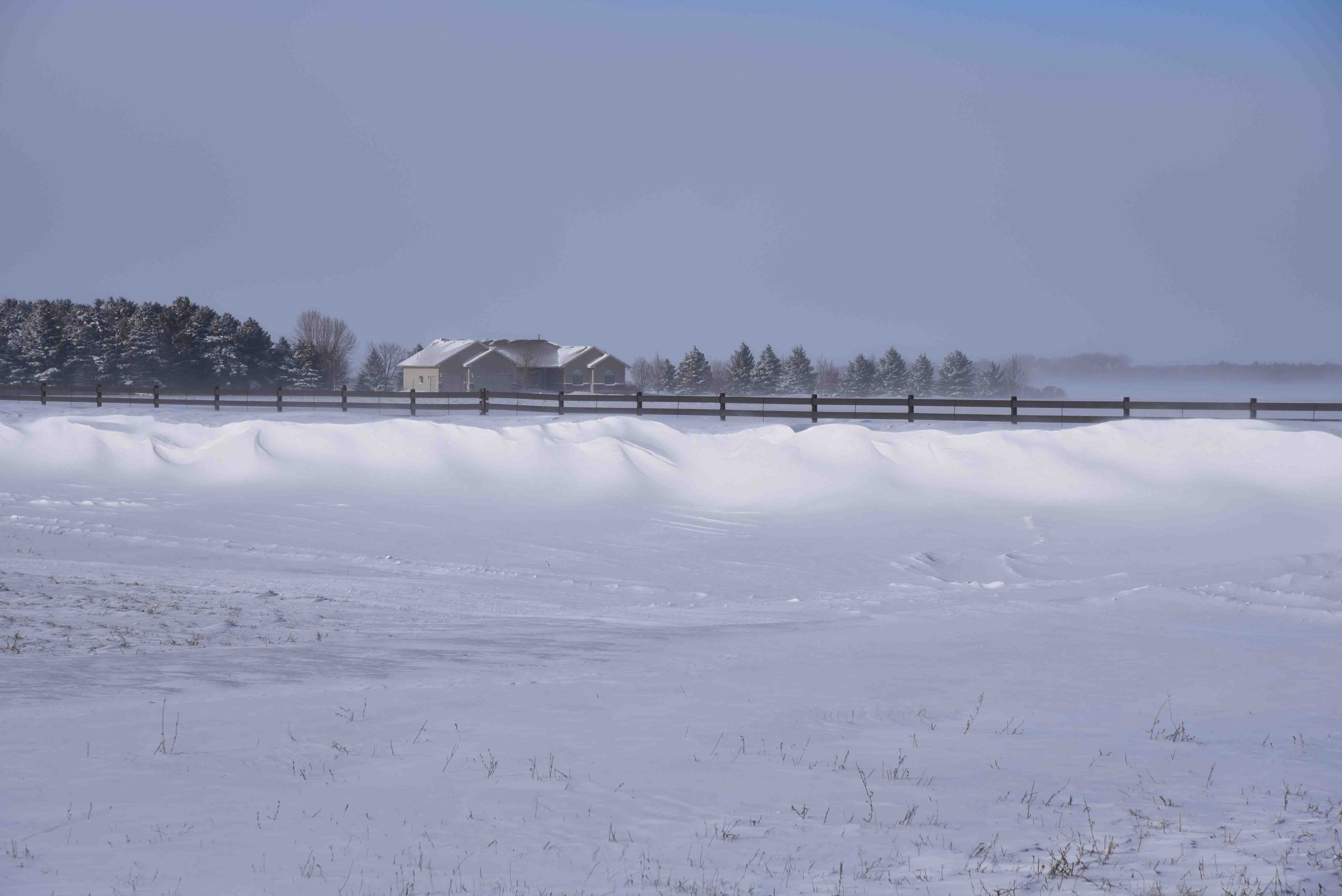 Structural snow fence and house on Hwy 10.